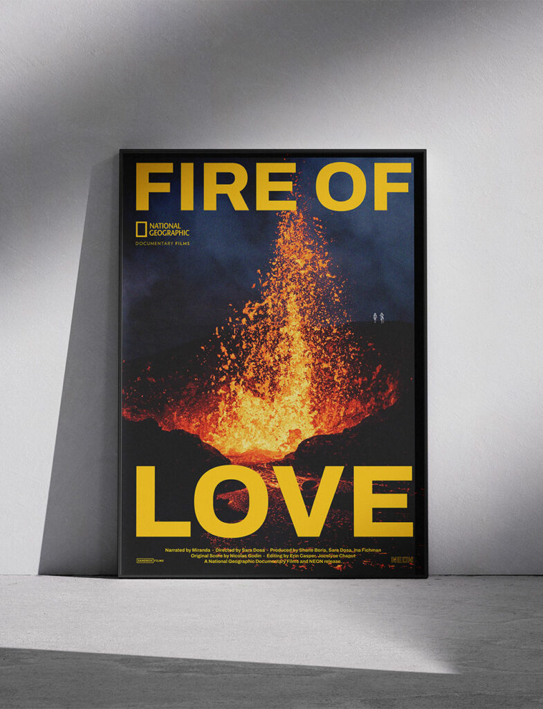Affiche poster du film FIRE OF LOVE posé sur le sol, avec une photo de volcan en éruption